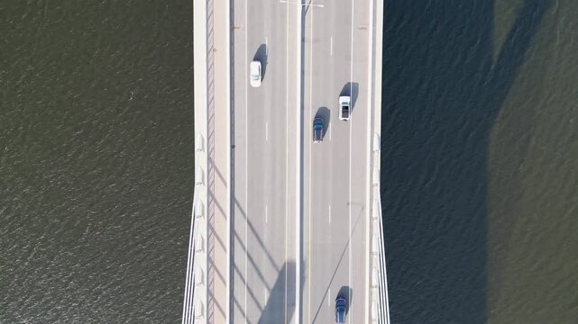 Above View Of Cars Across The Road Bridge Over The River 