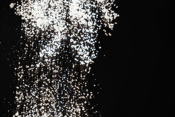 Obraz premium Abstract black and white background of pouring flour, space for text