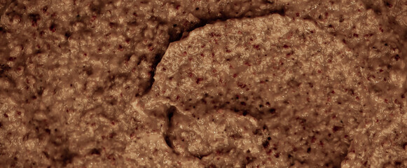 Chocolate ice cream with nuts and banana, texture. Chocolate smoothie cocktail close-up. Nut paste as a background.