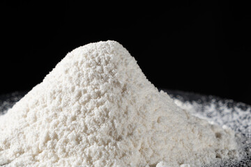 Close-up of natural coconut flour on a black background
