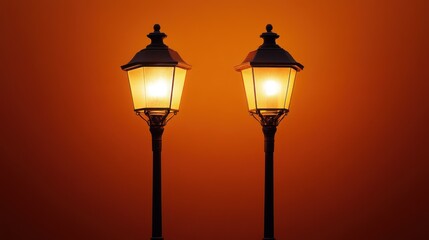 Two Illuminated Street Lamps Against a Sunset Sky