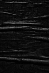 Dark black creased crumpled paper background surface old posters grunge texture backdrop surface empty space for text 