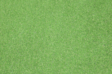 Artificial grass, covering. Artificial green grass mat, top view. Texture. Background. Artificial turf, surface made of synthetic fibers. Flat green grass texture background. Short grass