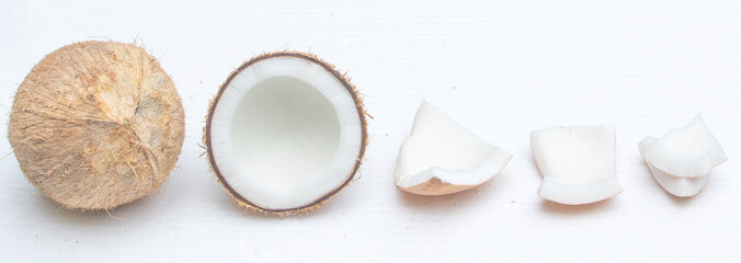 Half cut of coconut fruit and a piece on white background