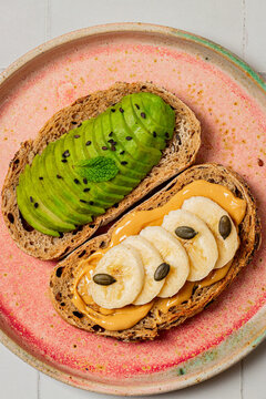 Avocado and Banana Peanut Butter Toast on a Pink Plate