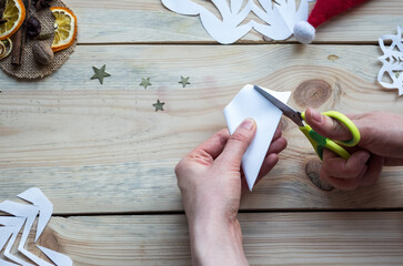 A snowflake made from paper with your own hands gracefully decorates a winter interior, adding warmth and a cozy atmosphere