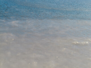A snow-covered river with an ice-covered area with footprints creates an atmosphere of winter adventure and freshness