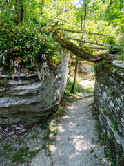 Sheer cliffs frame ancient ruins, reminiscent of past greatness, creating a mystical atmosphere and sense of time