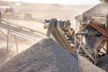 Crushing stones in a quarry for processing minerals, cement, limestone. Distribution and Screening Plant Gravel. Vibrating screen stone crusher in operation.
