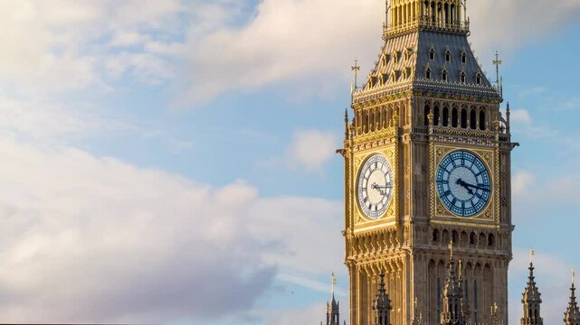 Close-up time lapse view of the Big Ben Tower in London, England, with golden sunlight during sunset time