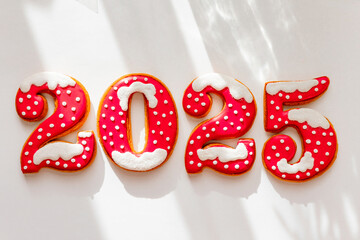 Christmas and New Year banner gingerbread cookies numbers 2025 on white background, copy space, minimalism