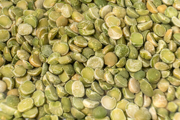 Close-up of uncooked green lentils, showcasing their texture and natural earthy tones. Ideal for healthy food concepts, vegan diets, or culinary backgrounds.