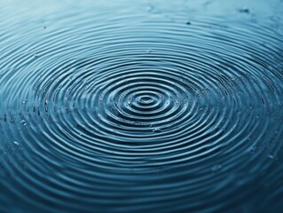 A serene close-up of ripples forming in tranquil water, showcasing a calming and peaceful natural pattern.