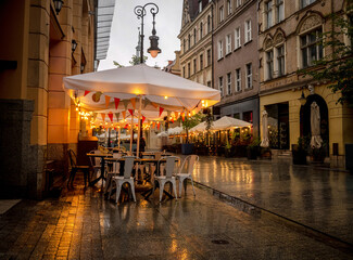 Street Cafe With Lights In The Evening On An Old Polish Street Exudes A Charming Ambiance
