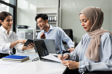 Mature teammates negotiate in board room, sit at table, exchanging opinions.