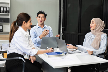 Mature teammates negotiate in board room, sit at table, exchanging opinions.