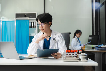 Medical Technology Concepts. The doctor is working on a tablet digital tablet computer in office  in the morning at the desk.