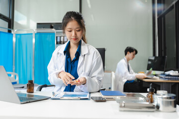female doctor writes prescription to patient at worktable.