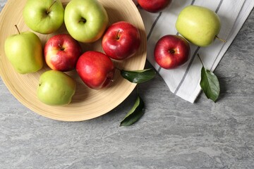 Fresh red and green apples on grey table, flat lay