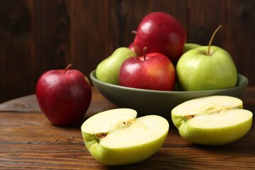 Fresh red and green apples on wooden table