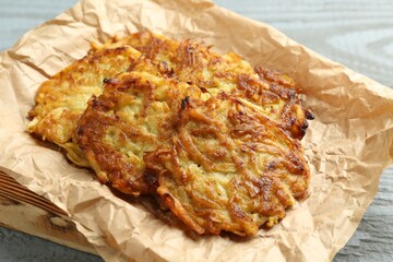 Delicious potato pancakes on grey table, closeup