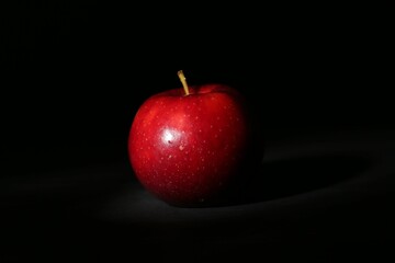 Fresh ripe red apple on black background, closeup
