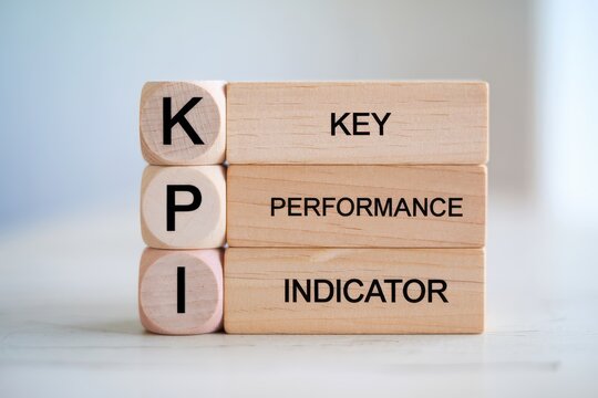 A Vertical Arrangement of Wooden Blocks Featuring Key Performance Indicator Letters for Business Insights
