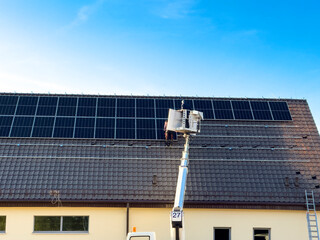 Installation of solar panels on the roof of a newly built retail store roof.