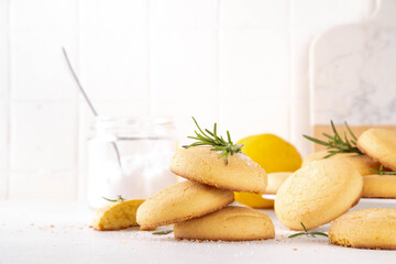 Savory rosemary and lemon shortbread cookies. Salted tasty cheese cookie appetizers with ingredients for cooking on white kitchen table