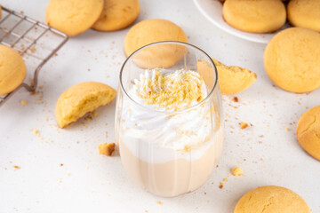 Shortbread sugar cookies milkshake, creamy shake drink with whipped cream and biscuits crumbs