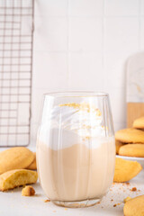 Shortbread sugar cookies milkshake, creamy shake drink with whipped cream and biscuits crumbs