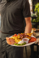Chef Serving Delicious Breakfast Platter with Eggs and Bacon