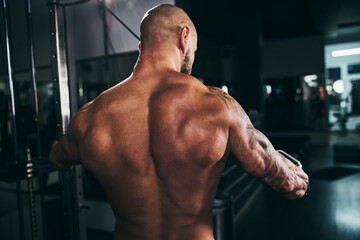 Fototapeta premium Fitness Man Showing His Muscles At The Gym