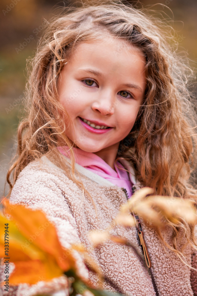 Wall mural child girl having fun on autumn forest