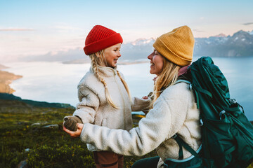 Mother and daughter traveling together family hiking in mountains, healthy lifestyle outdoor active vacations tour in Norway, woman backpacker having fun with child candid emotions, Mothers day