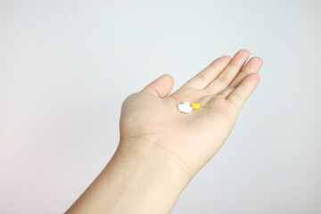 pills in outstretched hand isolated from background