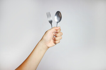 side view of metal fork and spoon on white background