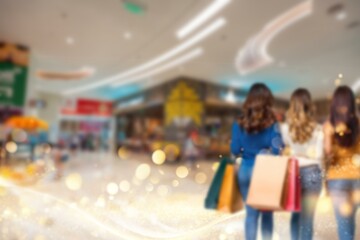 A blurred background with three women walking through a shopping mall in China. They are holding shopping bags and their legs are visible.