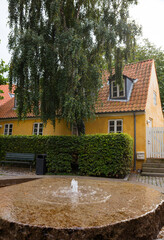 Charming Yellow House with Rustic Fountain in Lush Setting in ebeltoft denmark