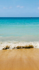 Beautiful view on blue sky and azure coast sea with soft blue ocean wave. Vertical photo. High quality photo