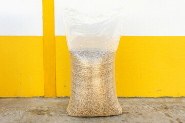 A 30 kg sack of animal feed oats, showcasing a natural grain texture. Ideal for agriculture, farming, or animal nutrition-related themes. © Jmanita