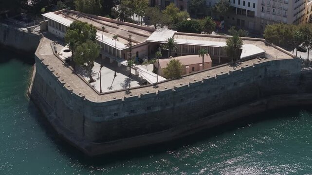 Aerial drone shot in Cadiz in Spain, Andalusia, Europe, on bright sunny day, facing Baluarte de la Candelaria. Shot in ProRes 422 HQ
