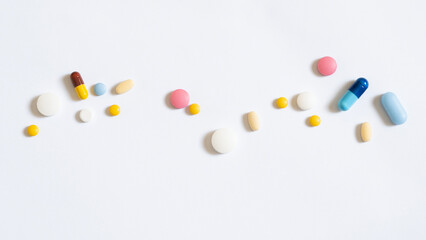 Pile of colorful medicine pills and capsules in blister packs.