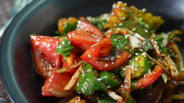 salad of ofaschi, pepper, greens. Garnished with sesame seeds and sauce