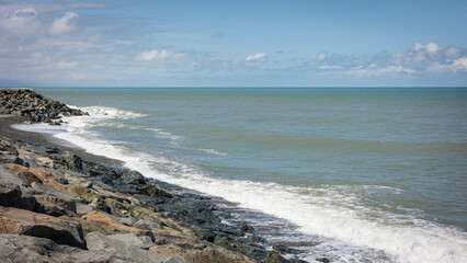 panoramic view of Batumi beach. Sea waves, stone shore with white foam. Georgia