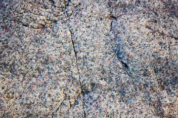 Cracked granite stone. Old granite.
