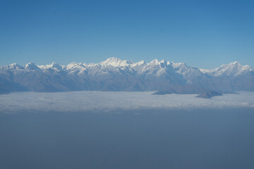 Snow-covered mountain range under a clear blue sky.