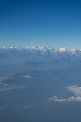 A stunning view of snow-capped mountains under a clear blue sky.