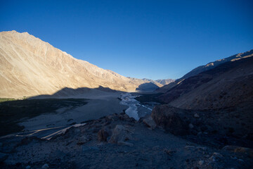 Twilight settling over a tranquil mountain river valley