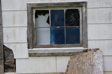 broken window in an abandoned wooden structure